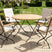MINT Outdoor Garden Dining Set featuring a round table and four stylish folding chairs
