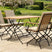 MINT Outdoor Garden Dining Set with a wooden tabletop and cushioned folding chairs for outdoor dining
