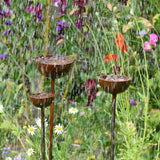 SavageWorksUK Rain Catcher in three tiers with water flowing, surrounded by vibrant flowers