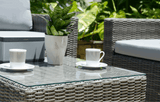 MINT Outdoor Garden Sofa Set featuring woven design, coffee table and stylish decor plants