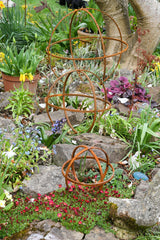 Rustic Garden Sphere Ornaments in a colourful flower garden with vibrant plants and flowers