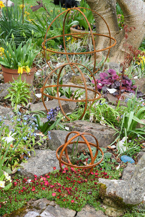 Rustic Garden Sphere Ornaments in a colourful flower garden with vibrant plants and flowers