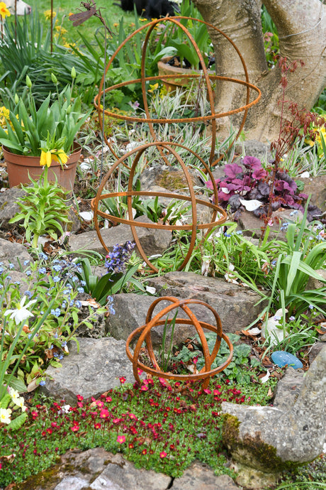 Rustic Garden Sphere Ornaments in a colourful flower garden with vibrant plants and flowers