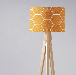Shadow bright geometric yellow lampshade on a wooden floor lamp for stylish interior lighting
