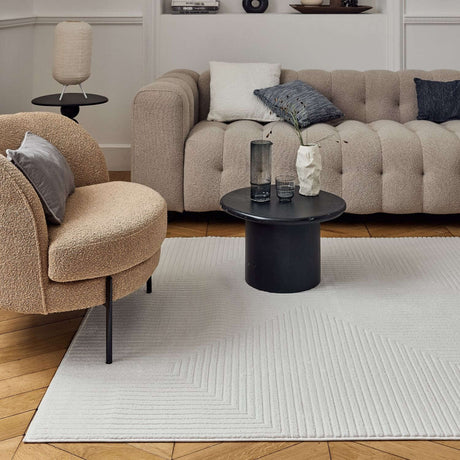 Modern geometric rug in a stylish living room with beige furniture and minimal decor