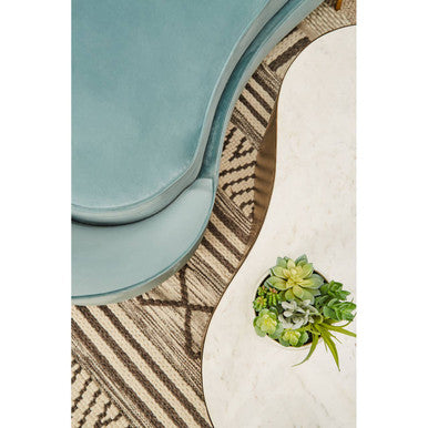 Stylish Orsina Geometric Rug with intricate patterns under a modern coffee table and plants