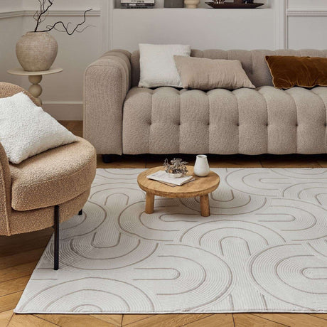 Stylish geometric rug on wooden floor beneath a modern sofa, ideal for contemporary living spaces