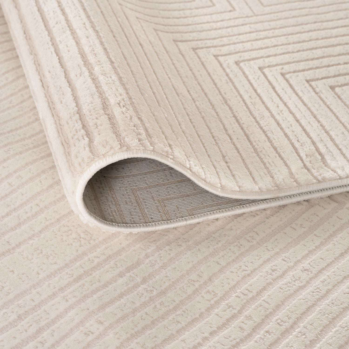 Soft cream Geometric Rug with subtle textured patterns, perfect for modern home decor