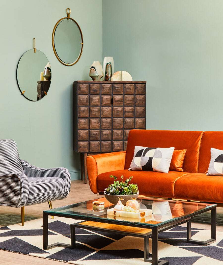 Orsina Geometric Rug in a stylish living room setting with orange sofa and coffee table