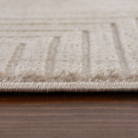 Close-up of a textured Geometric Rug with subtle patterns and a soft beige colour