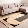 Orsina Geometric Rug in modern design, with soft colours and unique shapes, placed under a stylish sofa