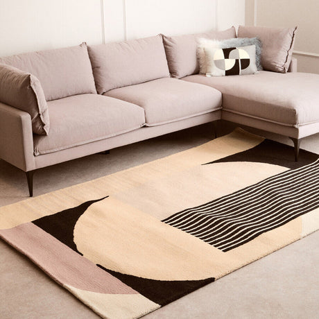Orsina Geometric Rug in modern design, with soft colours and unique shapes, placed under a stylish sofa