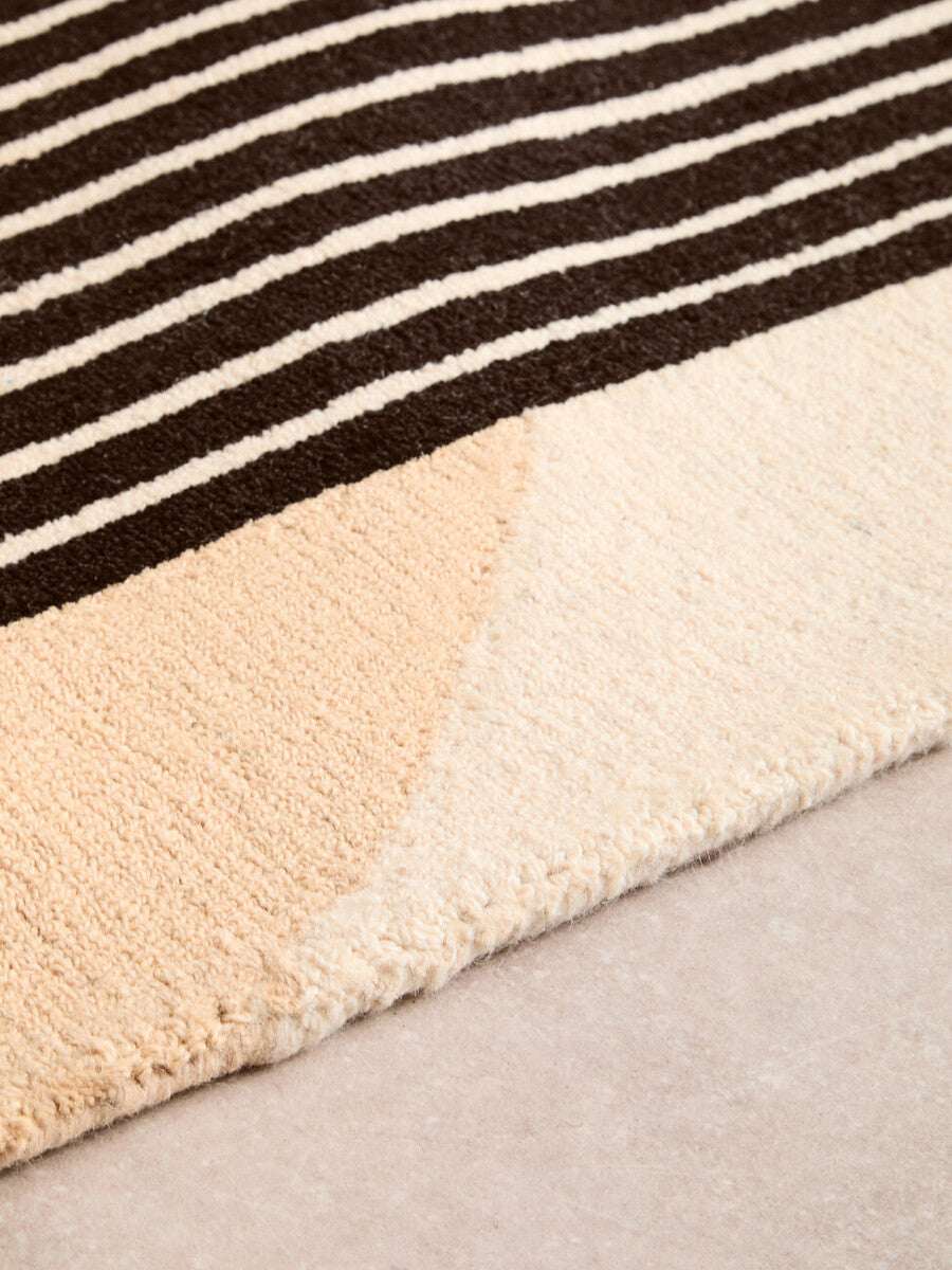 Orsina Geometric Rug featuring a striped pattern with soft beige and brown hues