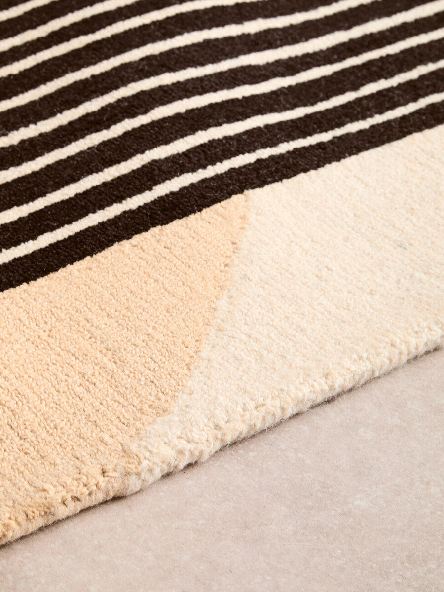 Orsina Geometric Rug featuring a striped pattern with soft beige and brown hues