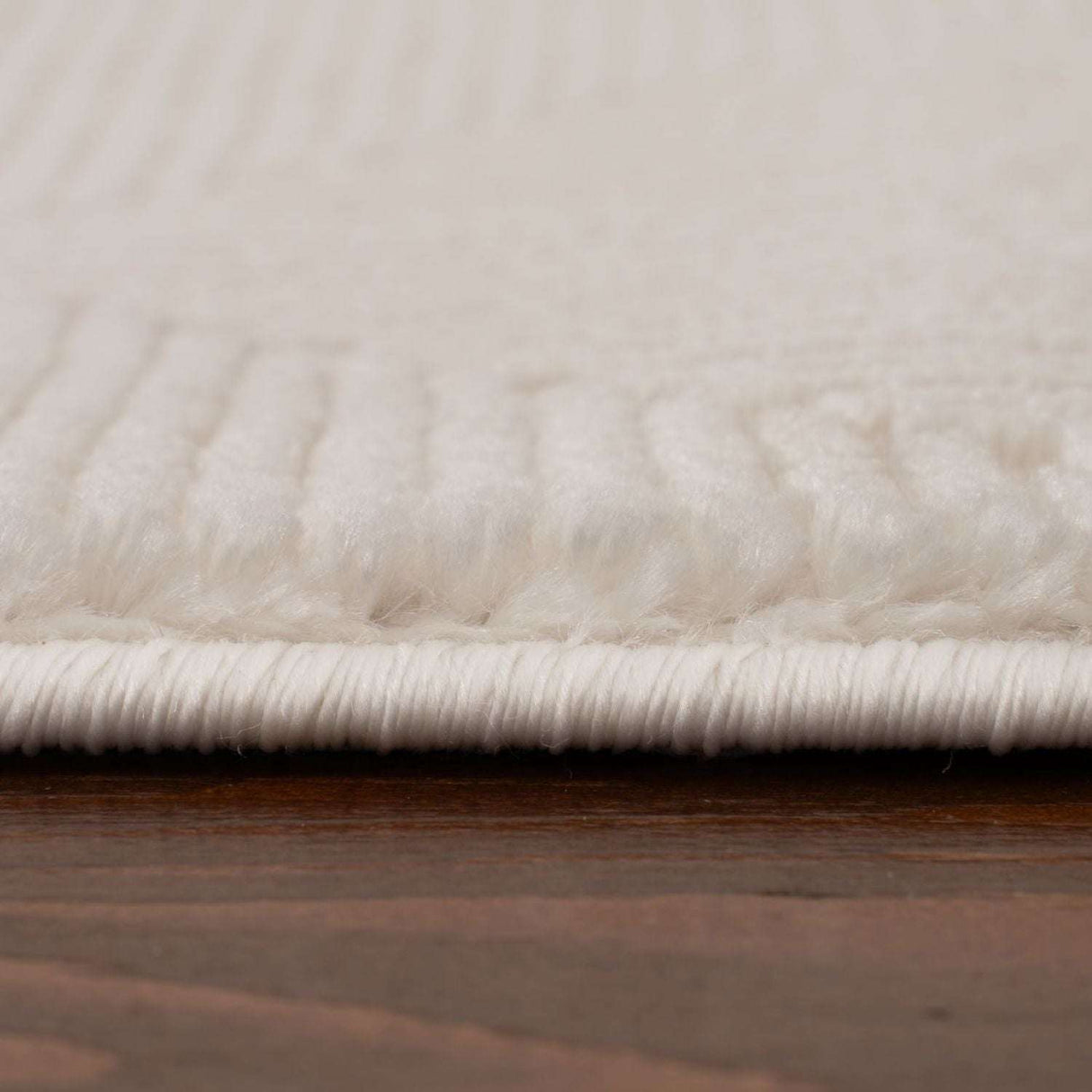 Close-up of a soft white Geometric Rug showcasing its plush texture and finely woven details