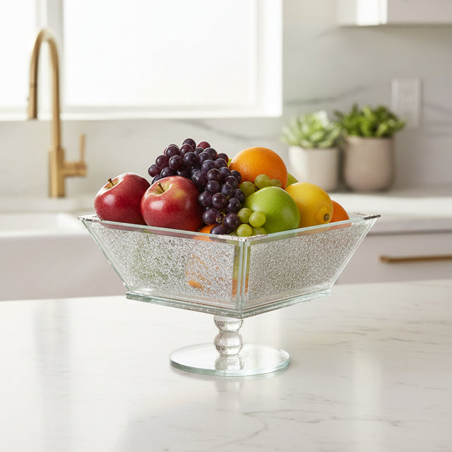 Elegant glass fruit bowl filled with vibrant apples, grapes, oranges, and pears for home decor