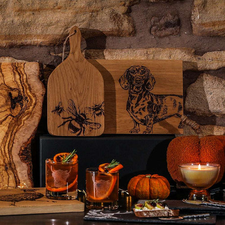 Stylish Glass Tumblers on a Rustic Table with Decorative Elements and Cocktails