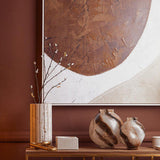 Orsina Glass Vase on a stylish table with abstract brown artwork in the background