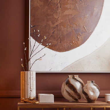 Orsina Glass Vase on a stylish table with abstract brown artwork in the background