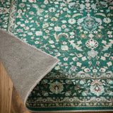 Intricate Green Rug with Floral Patterns and a Soft Border, Perfect for Home Decor