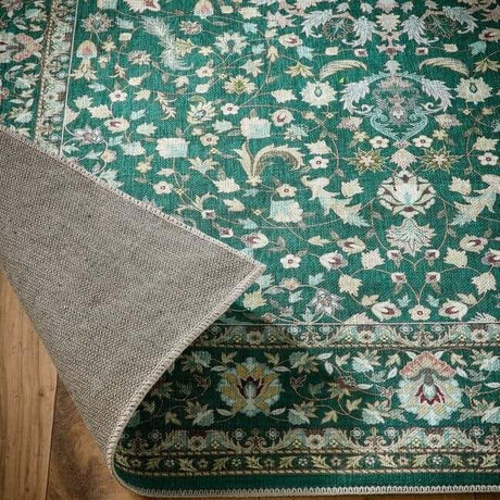 Intricate Green Rug with Floral Patterns and a Soft Border, Perfect for Home Decor