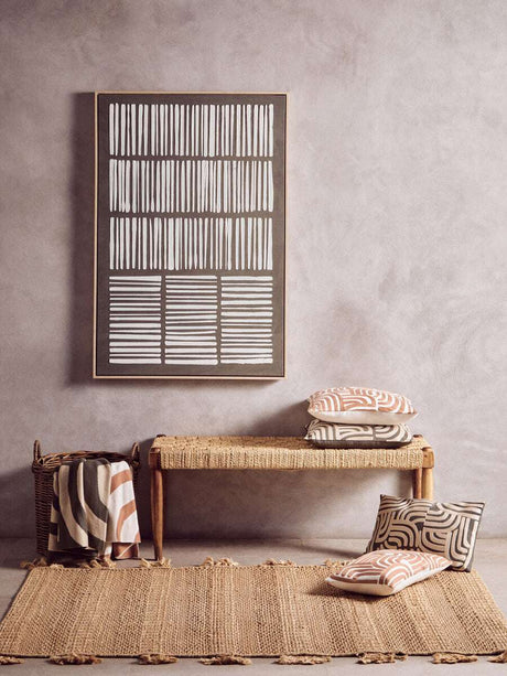 Stylish Orsina Green Throw draped on a woven bench with decorative cushions and wall art