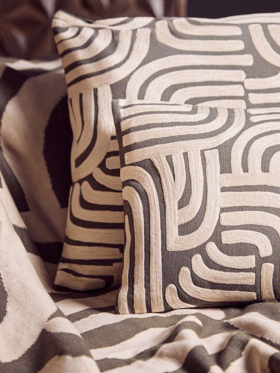 Orsina Green Throw draped elegantly with patterned cushions for a stylish home decor look