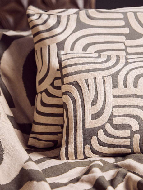 Orsina Green Throw draped elegantly with patterned cushions for a stylish home decor look