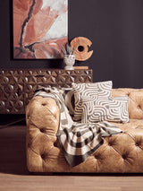 Stylish Green Throw draped on a leather sofa, complementing modern home decor