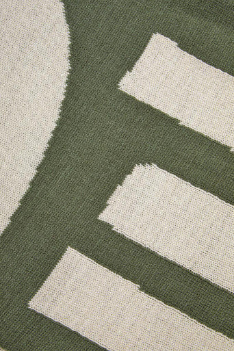 Close-up of an Orsina Green Throw featuring a modern design with neutral accents