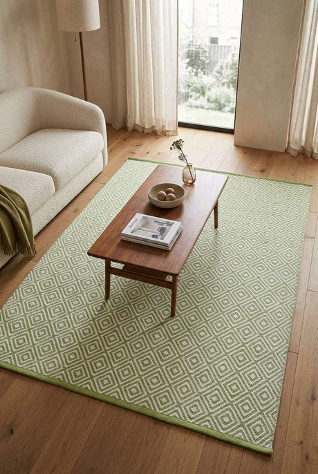 Stylish hand-woven rug in green and white geometric pattern, perfect for living room decor