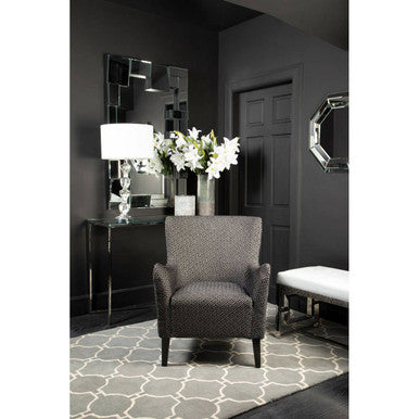 Orsina Hand Woven Rug in stylish living room setting with elegant armchair and decor