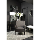 Orsina Hand Woven Rug in stylish living room setting with elegant armchair and decor
