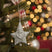 Hanging Santa Star decoration on a Christmas tree with festive lights and ornaments