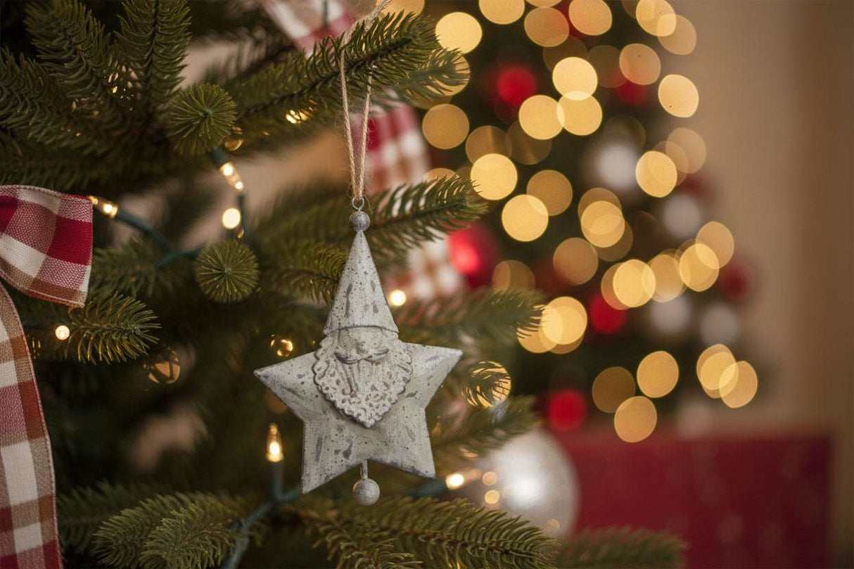Hanging Santa Star decoration on a Christmas tree with festive lights and ornaments