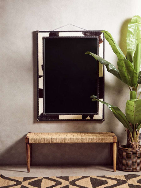 Orsina Hemp Rug in a stylish interior setting with a mirror and indoor plant