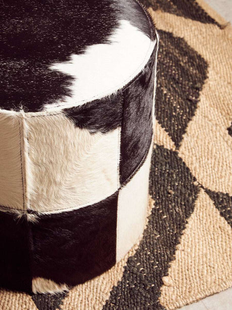 Orsina Hemp Rug featuring a natural texture with a stylish black and white pouf
