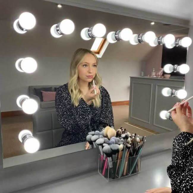 Hollywood Mirror with Bright Bulb Lights and Makeup Brushes for a Glamorous Beauty Setup