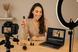 Content creator using Hollywood Mirror with makeup products at a video recording session