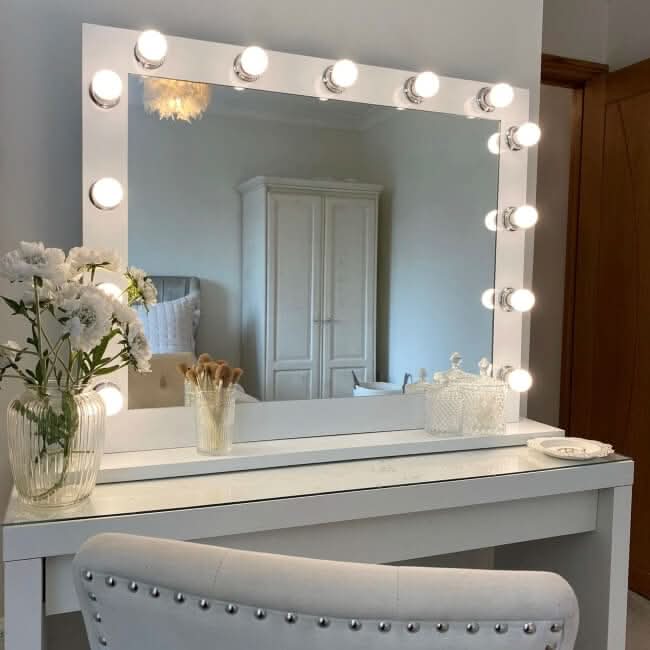 Stylish Hollywood Mirror with Bright Bulbs on a White Vanity, Perfect for Makeup Application