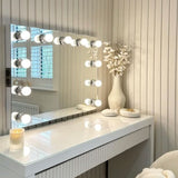 Stylish Hollywood Mirror with Bright Bulbs and Modern Vanity Table for Glamorous Spaces