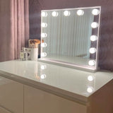Elegant Hollywood Mirror on a dresser with bright bulbs for perfect makeup lighting