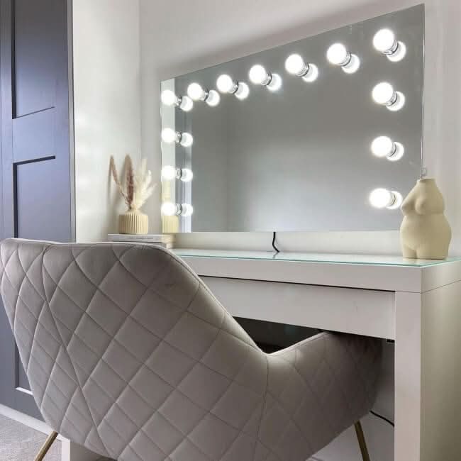 Hollywood Mirror with Bright Bulbs above a Glamorous Makeup Vanity Table