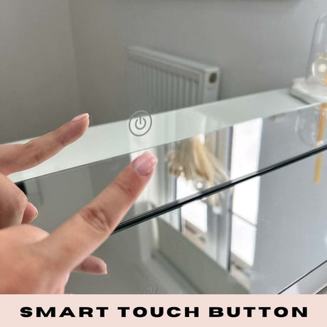 Close-up of a hand using the smart touch button on a Hollywood Mirror for easy adjustments