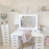 Elegant Hollywood Mirror above a stylish white vanity with soft lighting and decorative elements