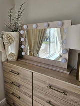 Hollywood Mirror with LED bulbs, stylishly placed on a wooden dresser in a bright room