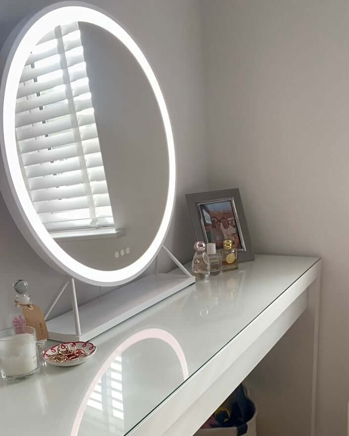 Stylish Hollywood Mirror with LED lighting on a modern vanity table with decorative items