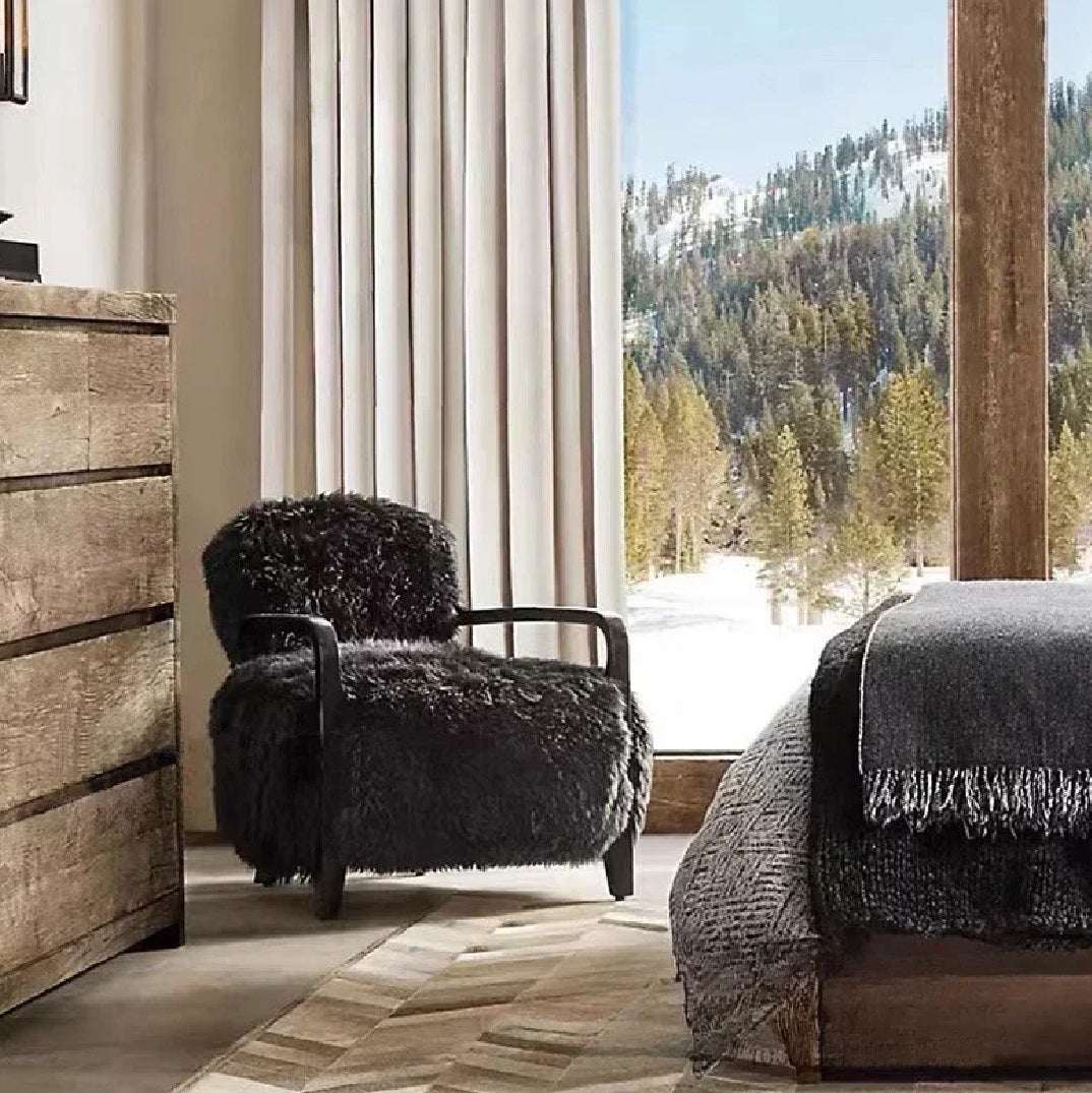 Nisu Home stylish armchair in a cosy room with mountains in the background, perfect for relaxation