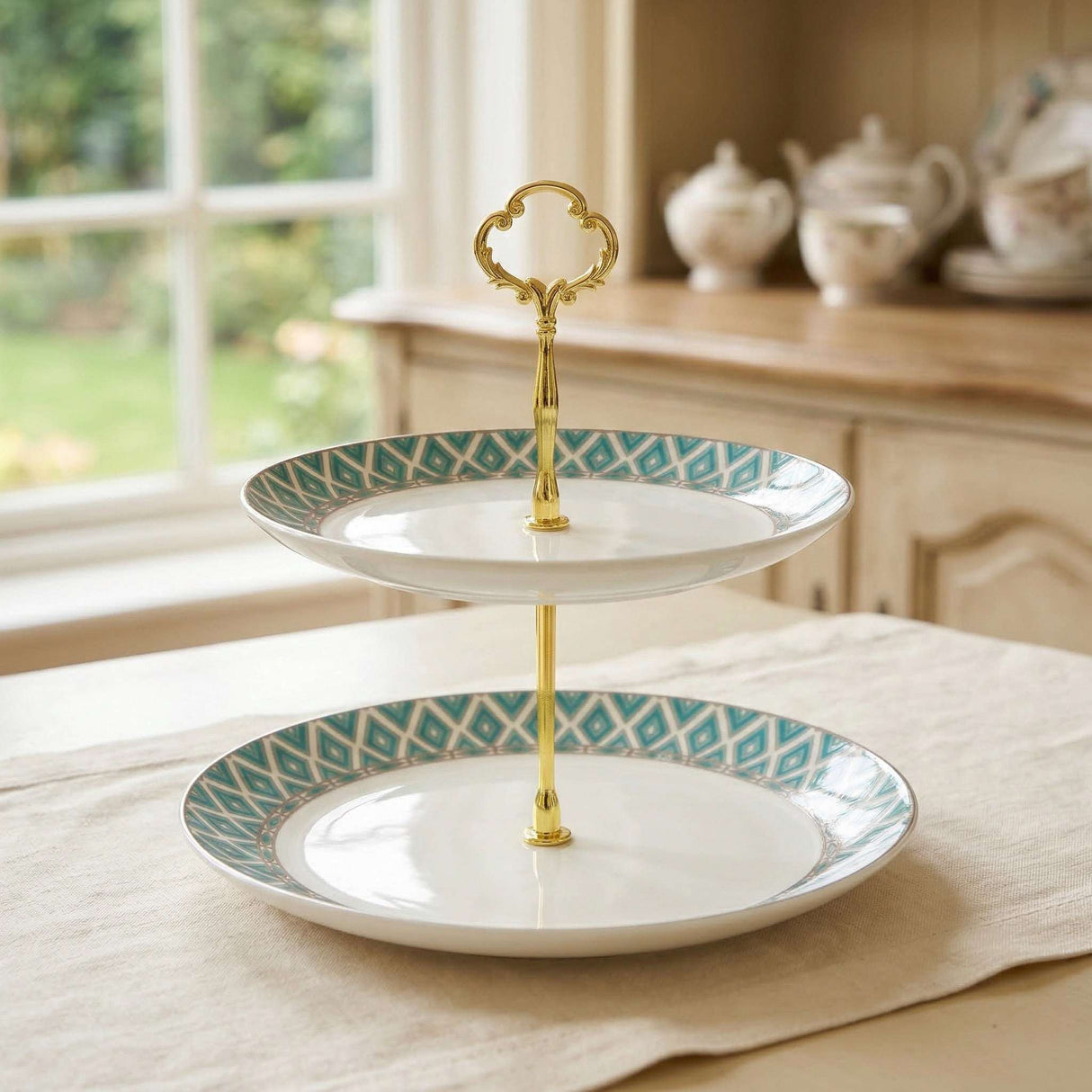 Elegant two-tier Cake Stand from KitchBoom with decorative blue pattern and gold handle