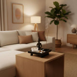 Buddha Ornament on a wooden coffee table with an incense holder and a plant in a modern living room
